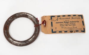A metal ring, souvenired from the Japanese Midget Submarine sunk in Sydney Harbour on 31 May 1942; together with official certificate of guarantee.
