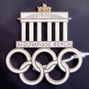 1936 Berlin Official Visitor's Badge/Pin, gold-plated iron, 54x58mm, cream-coloured enamel, Brandenburg Gate over Olympic rings, text "1936/ XI.Olympiade Berlin". G/VG condition (missing pin).