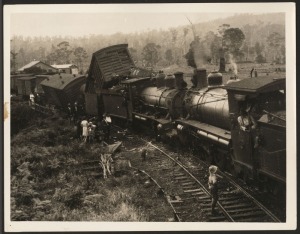 TOWNSVILLE EXPRESS COLLISION: 21.5 x 16.5cm press photograph of the 1933 head-on collision that occurred near the Eudlo&nbsp;Railway Station in Queensland, showing much wreckage, several onlookers, and the driver chatting with a passerby from the cab.