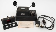 LEITZ: Leica LAVAR large slide printer base unit with instruction booklet, together with one ELDIA negative printing device, and two slide holders. (4 items)