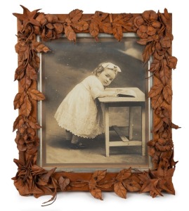 An antique&nbsp;Australian floral leather work picture frame housing a photographic portrait of a child, 19th century, note verso reads "The Elinore&nbsp;Wrobel Collection Cat. No. 59". 44 x 39cm overall