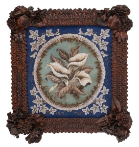 An antique Australian floral leather work picture frame, housing a beadwork floral tapestry, 19th century, 57 x 53cm overall