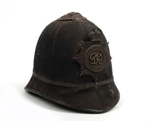 An antique English police "Bobby" helmet with George V hat plate, circa 1910.