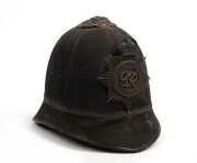 An antique English police "Bobby" helmet with George V hat plate, circa 1910.
