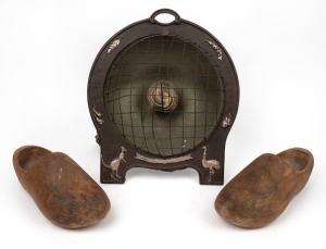 A vintage electric heater with cast iron mounts depicting a kangaroo and emu; together with a pair of kauri pine wooden clogs, unknown age and origin, the heater 41cm high overall