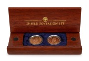A SHIELD SOVEREIGN SET from The Perth Mint: A small timber case containing an 1884S Victoria Young Head sovereign with Shield back, aUnc; together with an English 2002 Proof Sovereign with Shield back. Accompanied by a Certificate of Authenticity identify