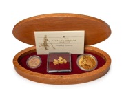 2003 AUSTRALIAN PROSPECTOR COLLECTION from The Perth Mint: comprising of the $100 (1oz) Canvas Town pure gold coin, an uncirculated 1903P Sovereign,&nbsp;and several loose Gold Nuggets weighing 7.34 grams. All presented in an oval-shaped timber case featuring 