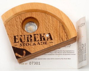 2004 $1 Eureka Stockade 150th Anniversary Silver Locket Coin incorporating small gold nuggets, attractively presented in a special timber case and accompanied by the Certificate of Authenticity No.07301.