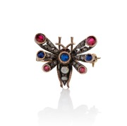 An antique insect brooch adorned with diamonds, rubies, sapphires and seed pearls, mounted in silver and rose gold, 19th century, 2.3cm wide, 4 grams.