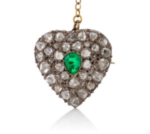 An antique heart brooch, pave set with old fashion rose cut diamonds and green stone, mounted in silver and rose gold with later gold safety chain, 19th century, 1.7cm high, 3.9 grams total