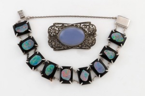 An English sterling silver and marcasite brooch with polished stone; together with a silver, opal and black glass bracelet, early to mid 20th century, (2 items), the brooch 4.5cm wide