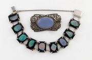 An English sterling silver and marcasite brooch with polished stone; together with a silver, opal and black glass bracelet, early to mid 20th century, (2 items), ​​​​​​​the brooch 4.5cm wide