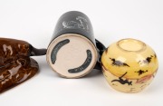 MARTIN BOYD pottery vase with Aboriginal hunting scene on yellow ground; together with a black Australian pottery mug with Aboriginal figure and a BENDIGO POTTERY platypus statue, (3 items), the platypus 17cm long - 2
