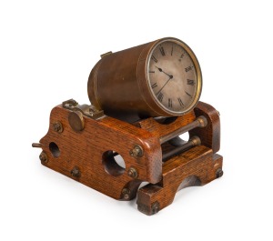 An antique novelty desk timepiece in the form of a mortar cannon, polished oak carriage with brass fittings, the cannon barrel with remnants of original gilt finish and English diamond registration mark, time only movement, lever escapement and silvered dial, circa 1870, 16cm high, 18cm wide, 14cm deep