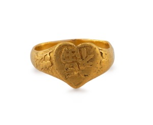 An antique Chinese 22ct gold ring with central heart shaped decoration with character for "Blessing" flanked by cherry blossoms, stamped with character marks to the inside, 19th century, 5.7 grams.