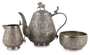 An antique Indian silver three piece tea service, decorated with palm trees and wild animals, 19th/20th century, the teapot 15cm high, 515 grams total