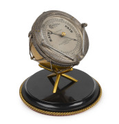 An antique desk barometer in the form of an orchestral timpani&nbsp;drum with engraved silver bezel, gilt metal finish and black slate base, by J. HICKS of London, 19th century, ​​​​​​​20cm high.