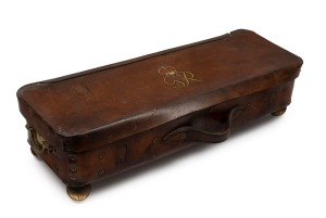An antique regalia leather case with brass carrying handles and bun feet, decorated with King George V cypher, circa 1910, ​​​​​​​69cm wide.