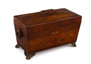 A Regency sarcophagus form tea caddy, strikingly veneered in kingwood with pressed and gilt brass paw feet and handle, interior fitted with two lidded compartments and original ruffled velvet lining, circa 1835, 20cm high, 32cm wide, 16cm deep.