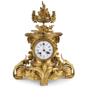 An antique French gilt bronze mantle clock with eight day time and bell striking movement and enamel dial, 19th century, 40cm high