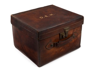 An antique English top hat in original brown leather case fitted with blue velvet and ownership monogram. 19th century, the case 43cm wide