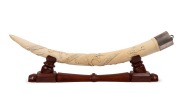 A pair of carved African ivory tusk ornaments mounted in sterling silver and presented on later carved timber stands, 60cm each - 2