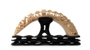 An antique Chinese carved hippopotamus tooth bridge on carved timber stand, 19th/20th century, ​​​​​​​18cm high, 34cm wide overall. - 2