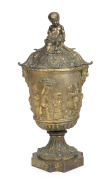 An antique French gilt bronze lidded mantle urn with cherub decoration, 19th century, ​​​​​​​42cm high.