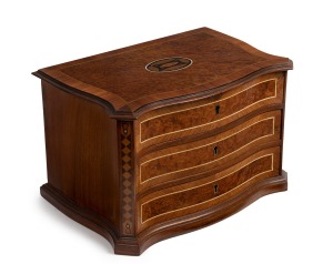 An antique French kingwood and amboyna miniature jewellery chest with lift top and compartments, serpentine front with string inlay and marquetry decoration, 19th century, 22cm high, 33cm wide, 23cm deep.