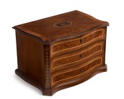 An antique French kingwood and amboyna miniature jewellery chest with lift top and compartments, serpentine front with string inlay and marquetry decoration, 19th century, 22cm high, 33cm wide, 23cm deep.
