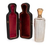 An antique French cut crystal scent bottle with 15ct gold top, original stopper plus leather and&nbsp;silk lined case, 19th century, ​​​​​​​the bottle 9cm high overall.