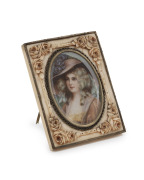 An antique French miniature portrait of a lady in a red dress and hat, housed in a fine quality carved ivory and Continental silver frame with easel stand, 19th century, ​​​​​​​8.5 x 6.5cm overall.