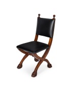 An antique Queensland maple and black leather cross framed hall chair with carved lion paw feet, 19th/20th century, 94cm high
