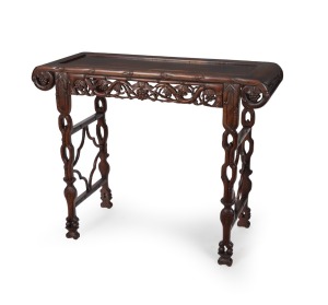 An antique solid rosewood&nbsp;Chinese export side table&nbsp;with recessed camphor top, scroll ends and trestle supports with well carved vine leaf apron, circa 1910, 87cm high, 109cm wide, 41cm deep