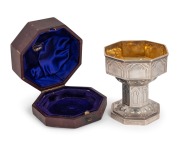 An antique sterling silver chalice cup (in two sections), with repousse angel decoration and housed in original plush fitted box, made in London, circa 1875, bearing church inscriptions to base, the cup 10cm high, 188 grams