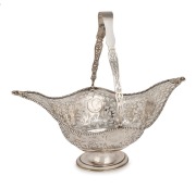 An antique pierced sterling silver cake basket, inset with Queen Anne silver crowns, made by George Nathan & Ridley Hayes of Chester, circa 1910, ​​​​​​​31cm high, 34cm wide, 673 grams