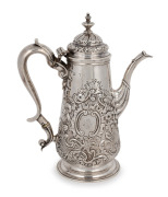 A Georgian sterling silver coffee pot with ornate floral repousse decoration and engraved rampant lion family crest, marks rubbed, 23cm high, 693 grams