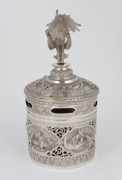 A Burmese circular lidded box with ornate repousse decoration and well cast figural finial, 19th/20th century, 23cm high, 604 grams total - 2