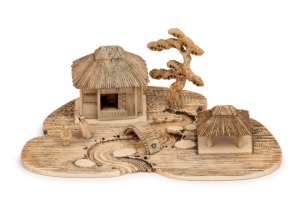 An unusual Japanese miniature carved ivory village landscape, Meiji Period, 19th/20th century, 4cm high, 11cm wide