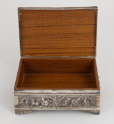 A Burmese silver casket ornately adorned with repousse figural decoration on all sides, interior lined in rainforest hardwood, 8cm high, 15cm wide, 10cm deep, 612 grams total (including timber lining) - 3
