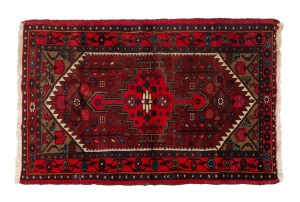A Persian hand-knotted wool rug with red ground, 155 x 100cm