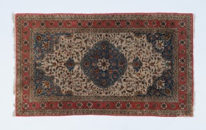 A Persian hand-knotted silk and fine cotton rug with red, blue and cream ground, 135 x 77cm