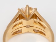 An 18ct gold ring, set with an approximately 1ct brilliant cut diamond flanked by six diamonds on each shoulder, 20th century, 6.3 grams - 2