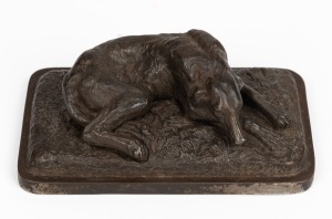 A cast metal dog paperweight, signed and dated "Ilsenburg, 1878", 3cm high, 9cm wide, 5cm deep