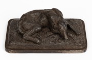 A cast metal dog paperweight, signed and dated "Ilsenburg, 1878", 3cm high, 9cm wide, 5cm deep
