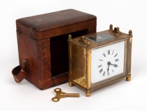 An antique French brass cased travelling clock in original scarlet leather case, 19th century, (missing handle), 9cm high