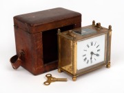 An antique French brass cased travelling clock in original scarlet leather case, 19th century, ​​​​​​​(missing handle), 9cm high