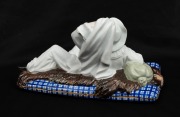 An antique hand-painted German porcelain figurine of Gaultier on a bear skin rug, circa 1880, 20cm long - 2