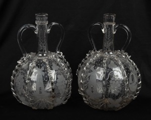 A pair of Continental glass wine decanters with engraved windmill and grape decoration, 23cm high