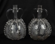 A pair of Continental glass wine decanters with engraved windmill and grape decoration, 23cm high